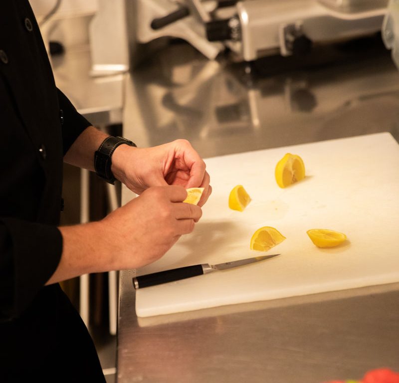 team member preparing lemon wedges